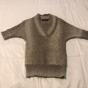Express warm tan and cream sweater to the sleeve